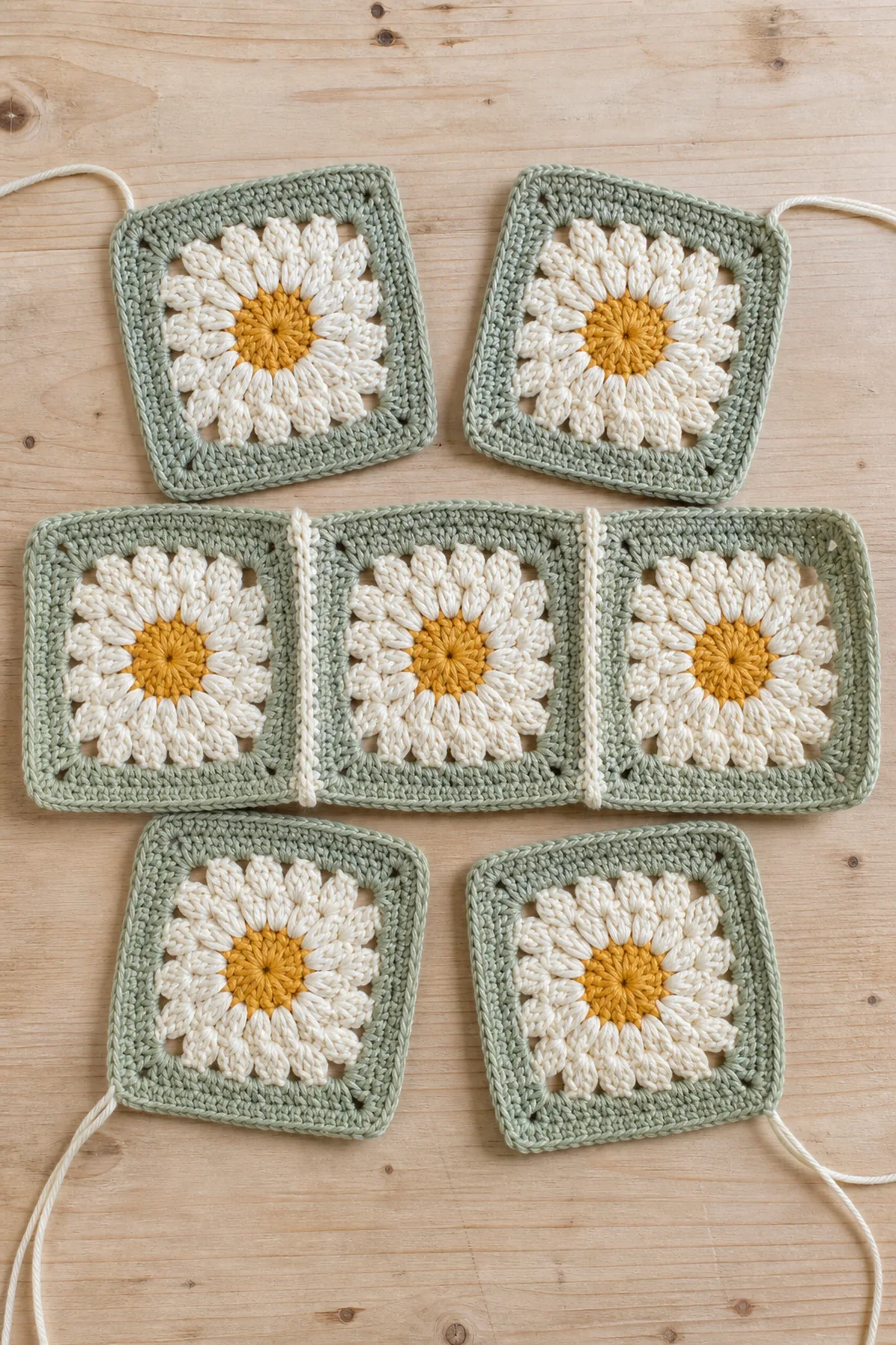 Six blocked daisy granny squares arranged for crochet bucket hat assembly
