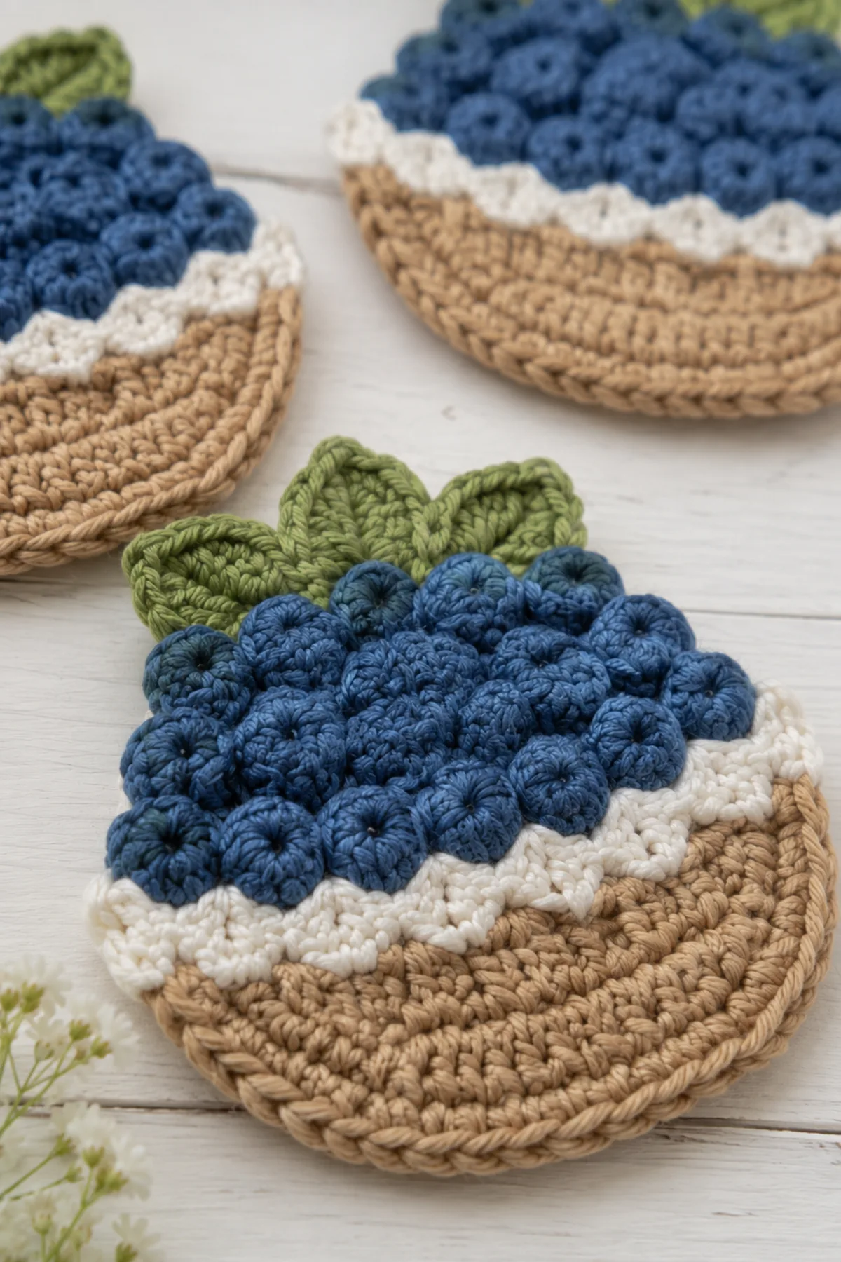 Close-up of the stitch texture and finishing details on crochet berry basket coasters