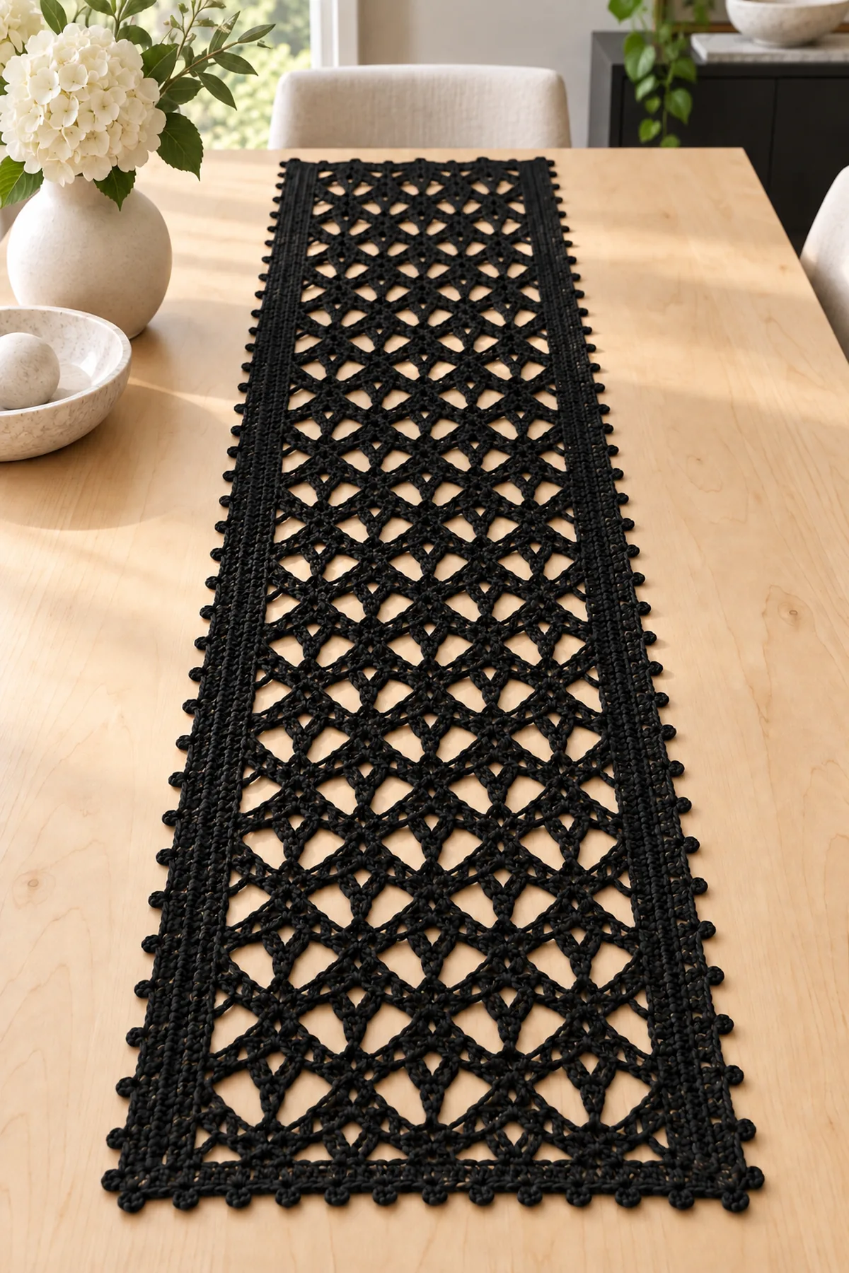 Black diamond mesh crochet table runner styled on a light modern dining table