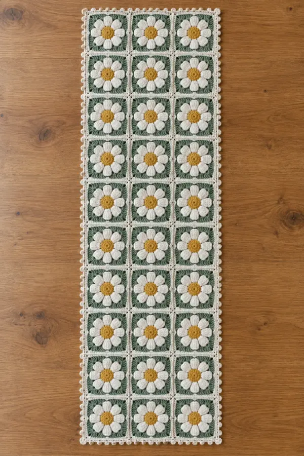 Finished crochet daisy chain table runner made from thirty joined sage ivory and gold floral squares