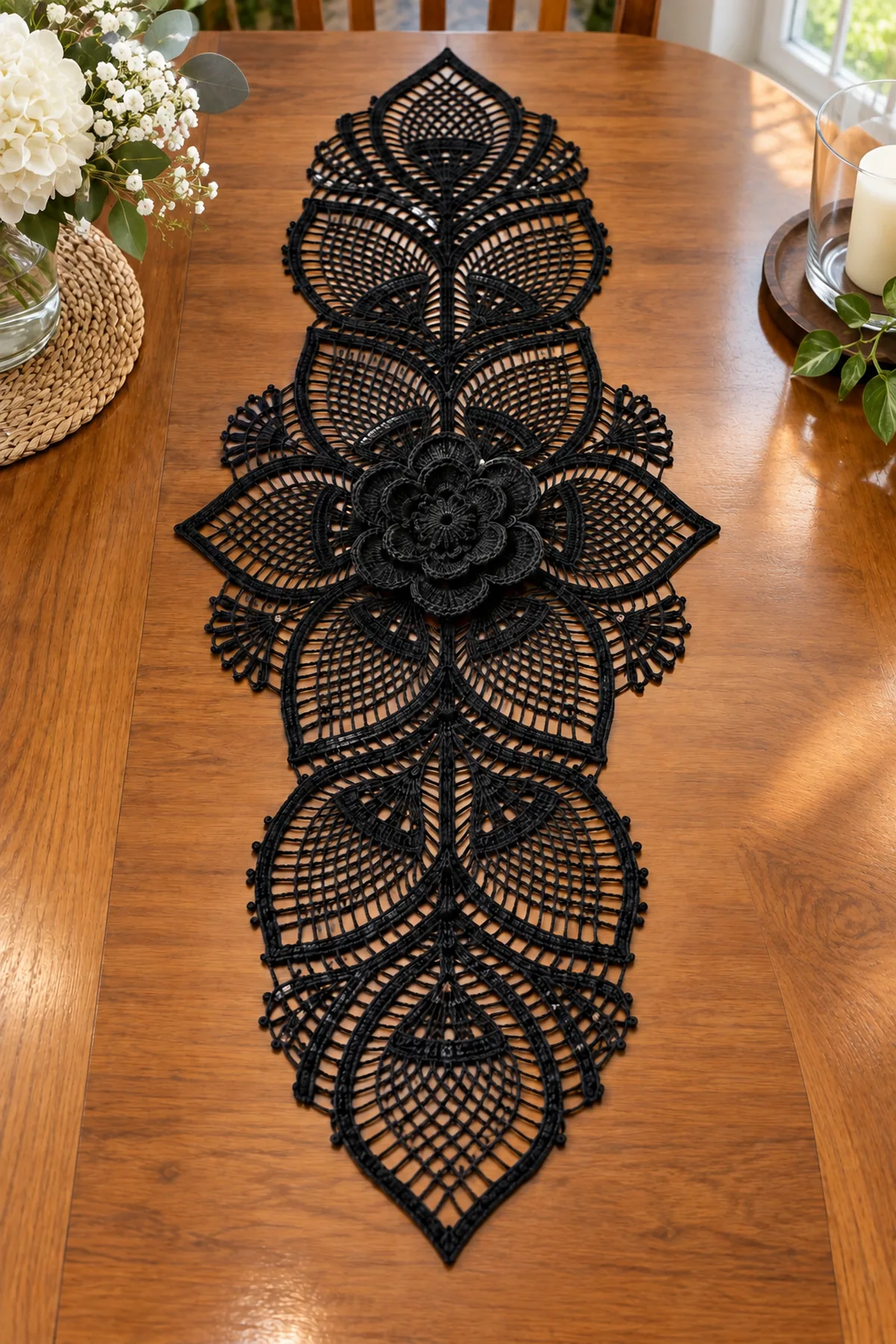 Elegant black lace floral crochet table runner styled on a polished wood dining table