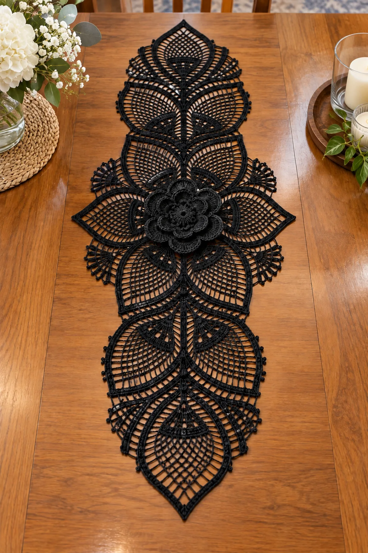 Fourteen black lace leaf motifs and fan connectors pinned around a center rose