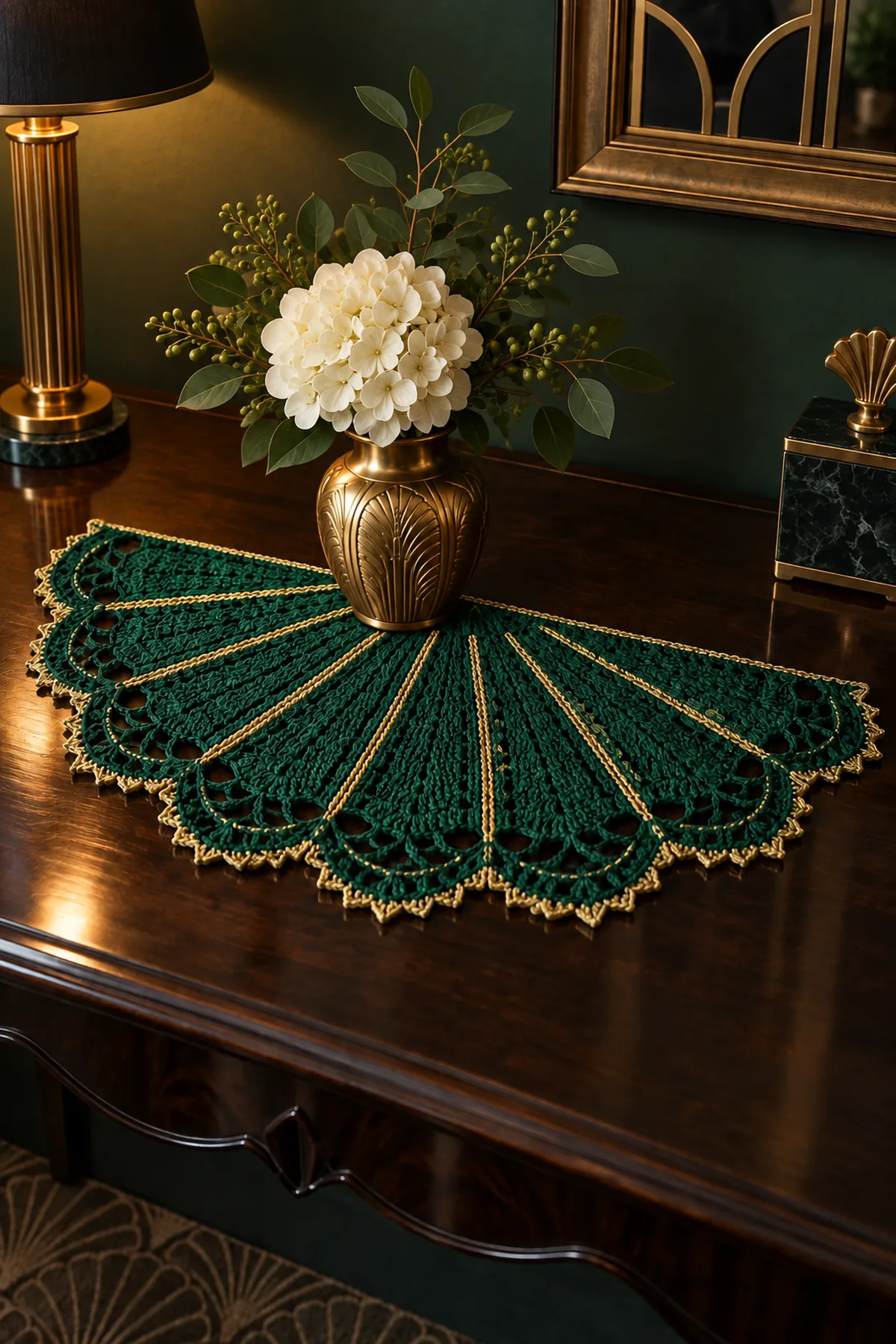 Emerald Art Deco crochet fan mat styled beneath a gold vase on a console table