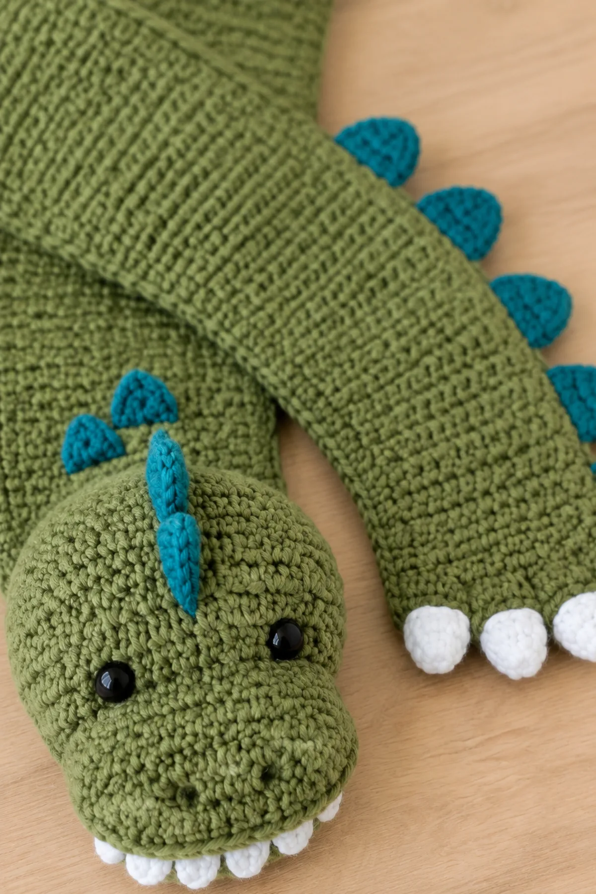 Close-up of the stitch texture and finishing details on easy crochet dinosaur toddler scarf