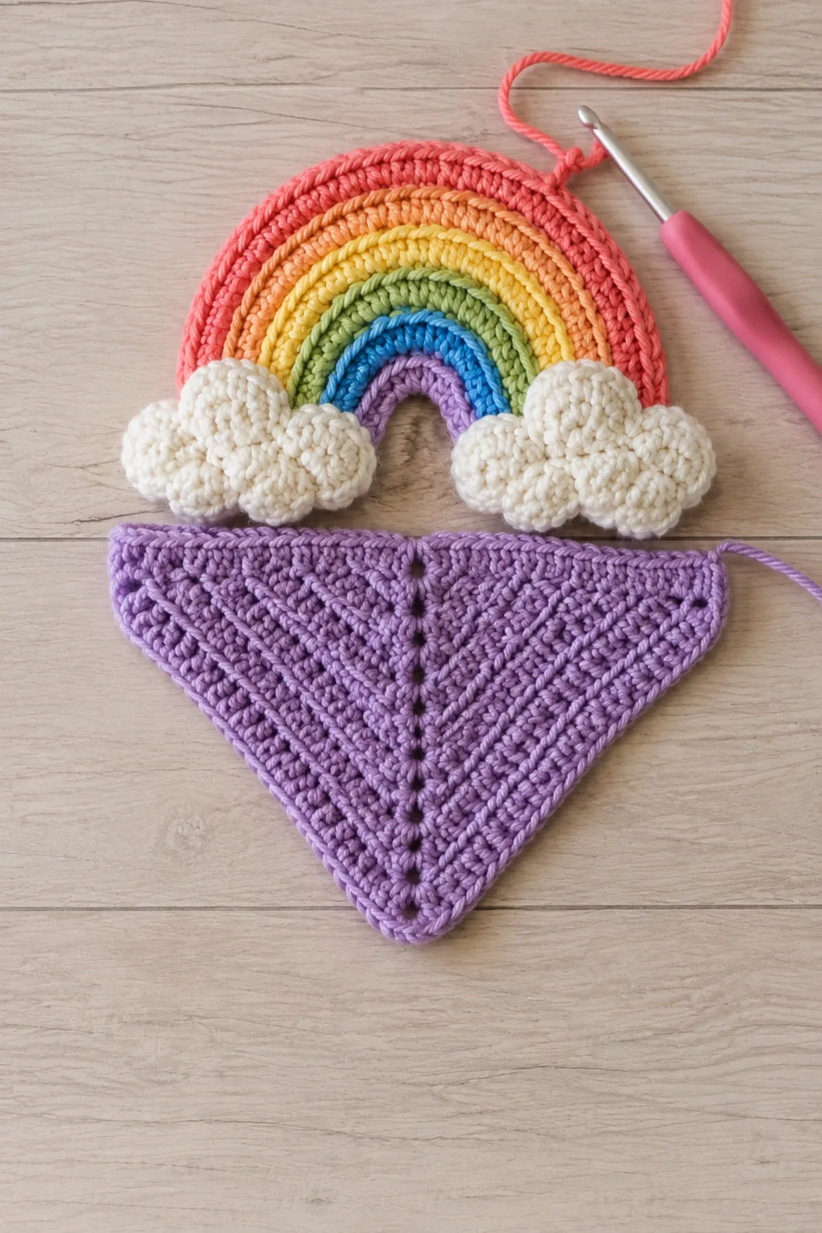 Early crochet construction stage for easy crochet rainbow baby lovey with working yarn and hook