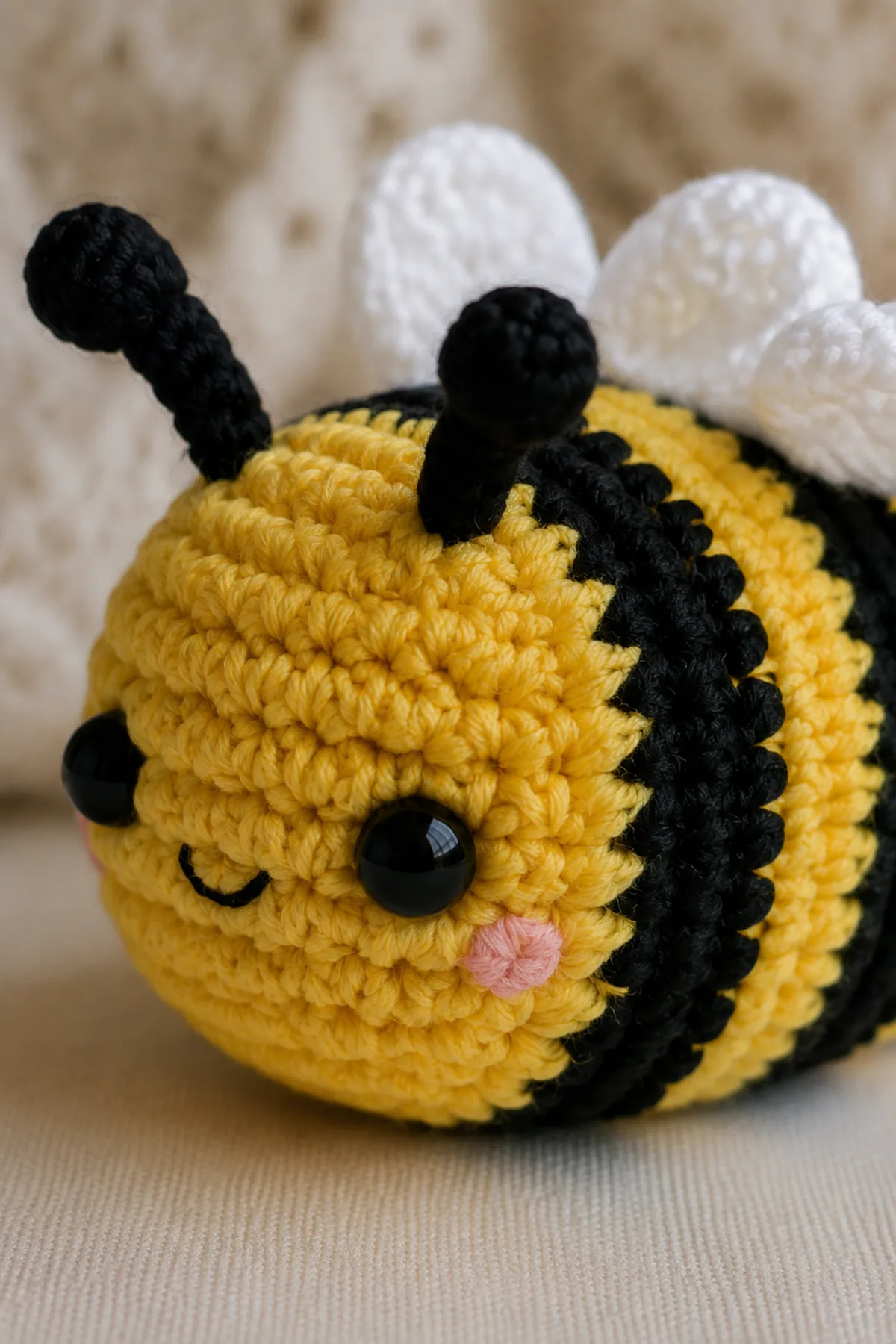 Close-up of the stitch texture and finishing details on mini crochet bumblebee amigurumi